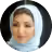 Portrait of a woman wearing a white headscarf and light makeup, smiling softly.