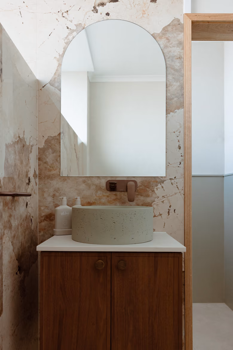 A bathroom with feature wall behind