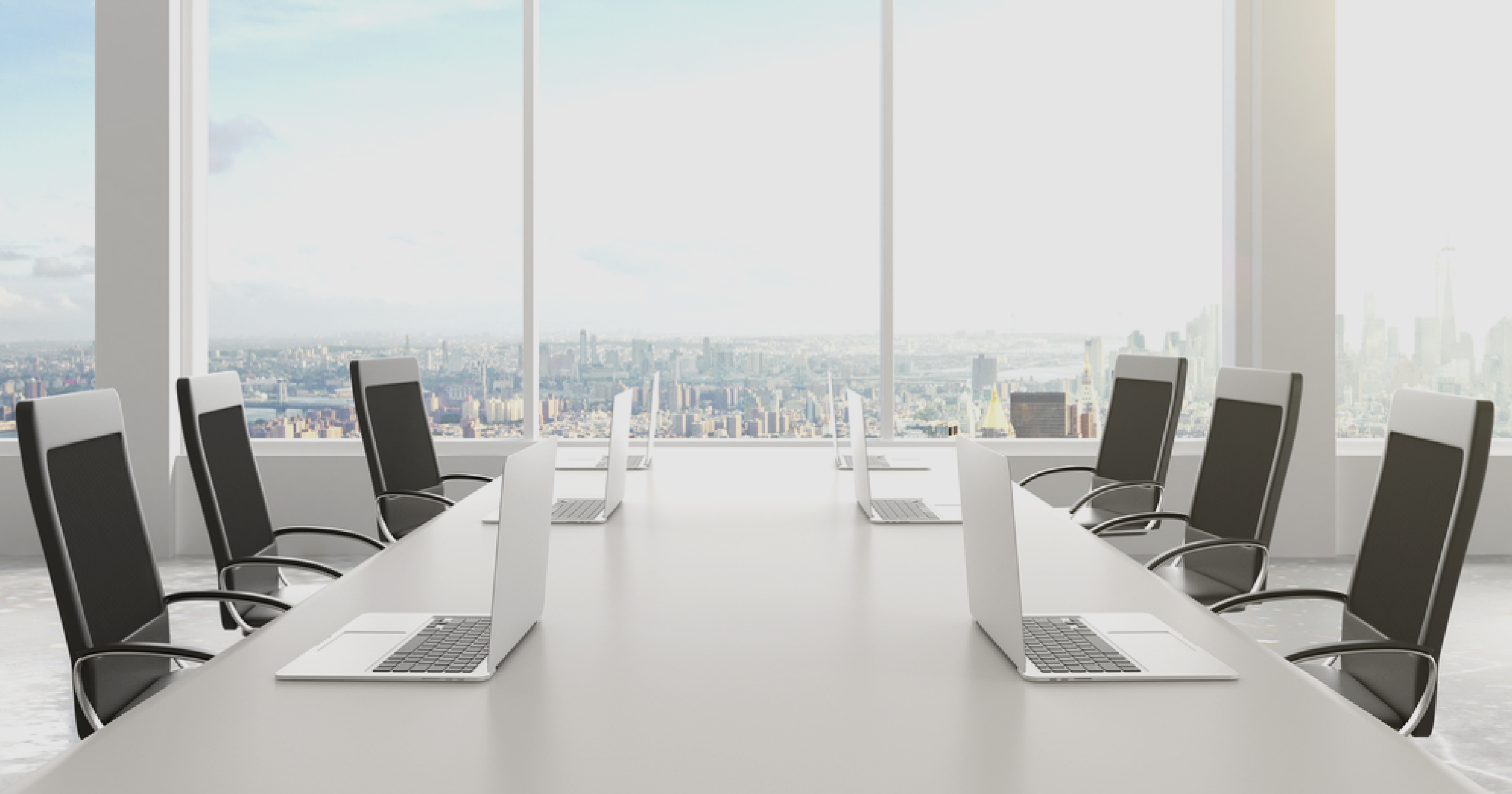Six unattended laptops on a conference table