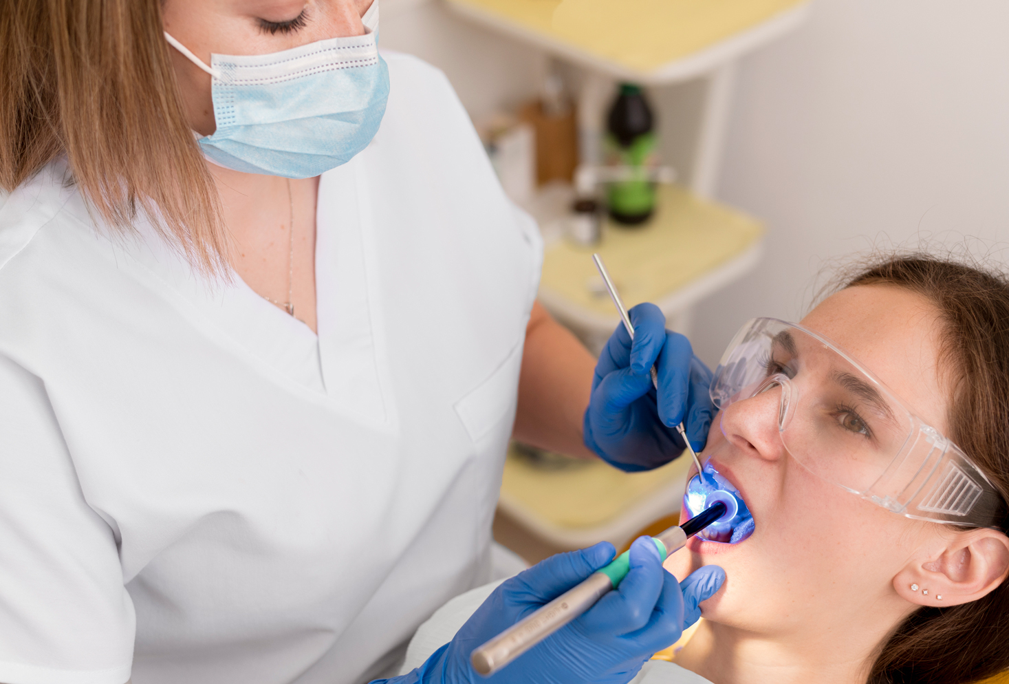 Dentist checking a patient's mouth after a tooth extraction