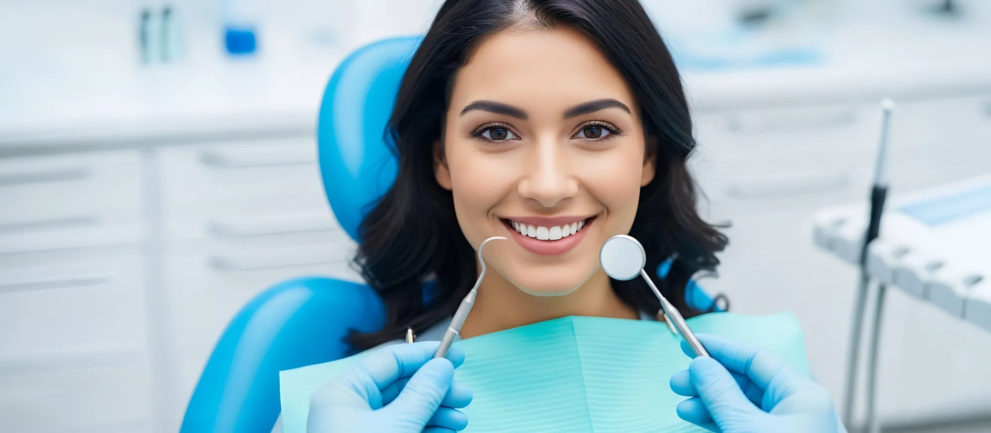 Smiling patient in the dental chair with dental instruments at MacArthur Dental Arts
