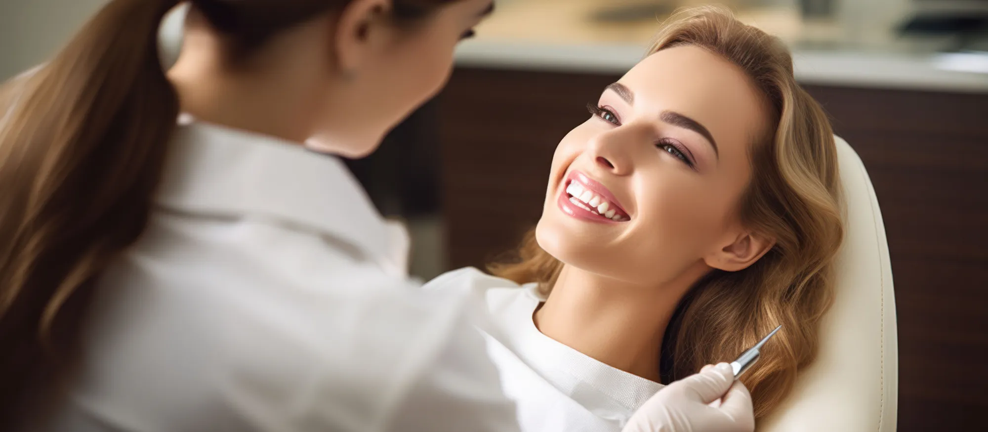 Patient smiling with her dentist at MacArthur Dental Arts in Irvine, CA