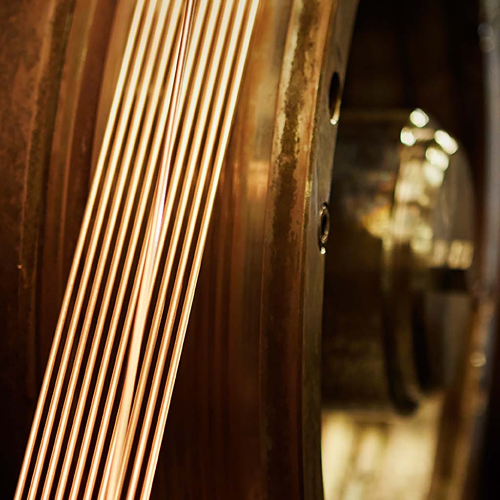 Rows of circular stators with copper wire coils arranged on a black surface.