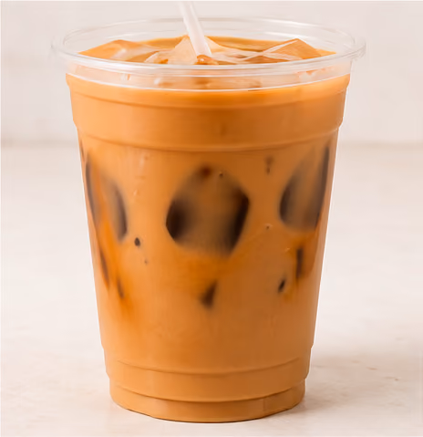 Plastic cup filled with iced latte showing coffee and milk swirls with ice cubes and a straw.