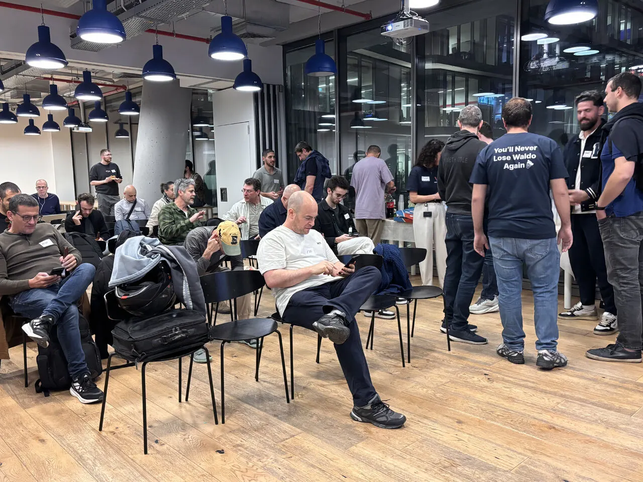 Attendees seated and talking before the meetup talks begin