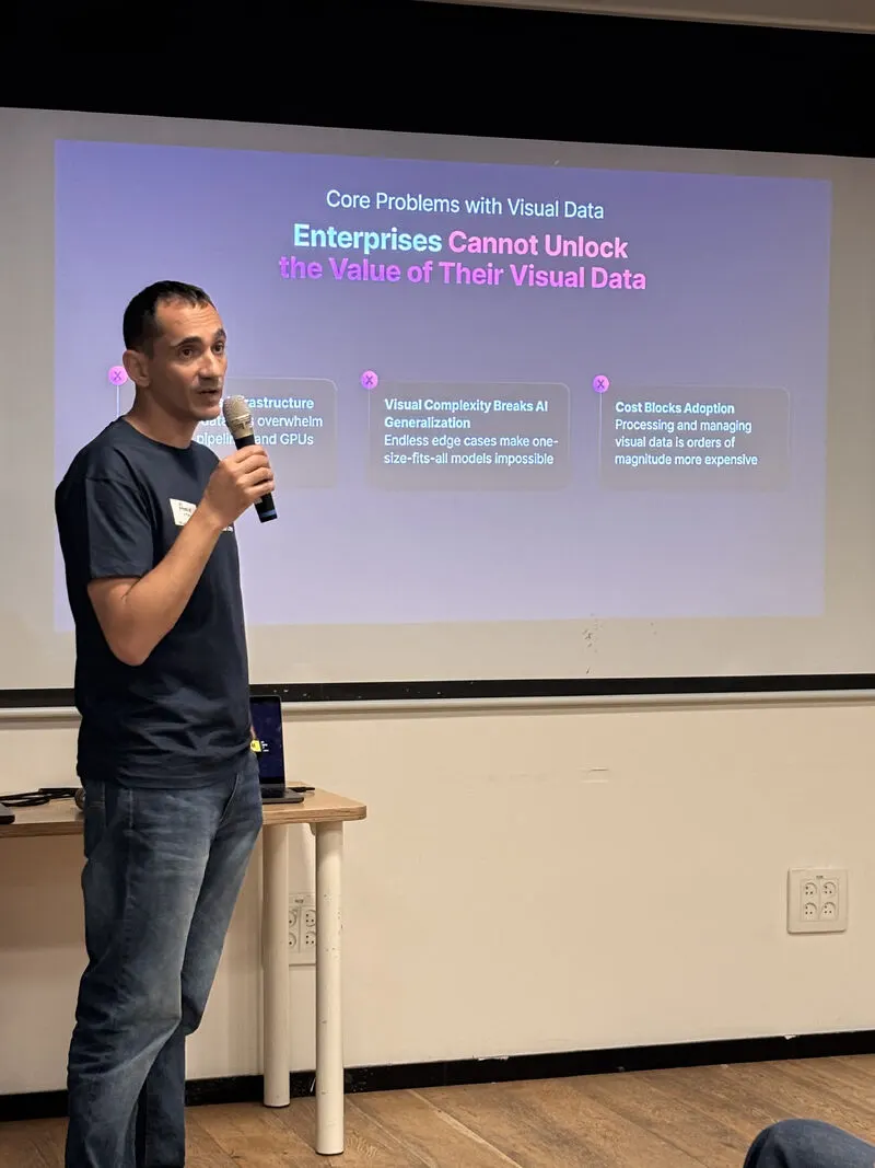 A speaker presenting a slide on the core problems with visual data