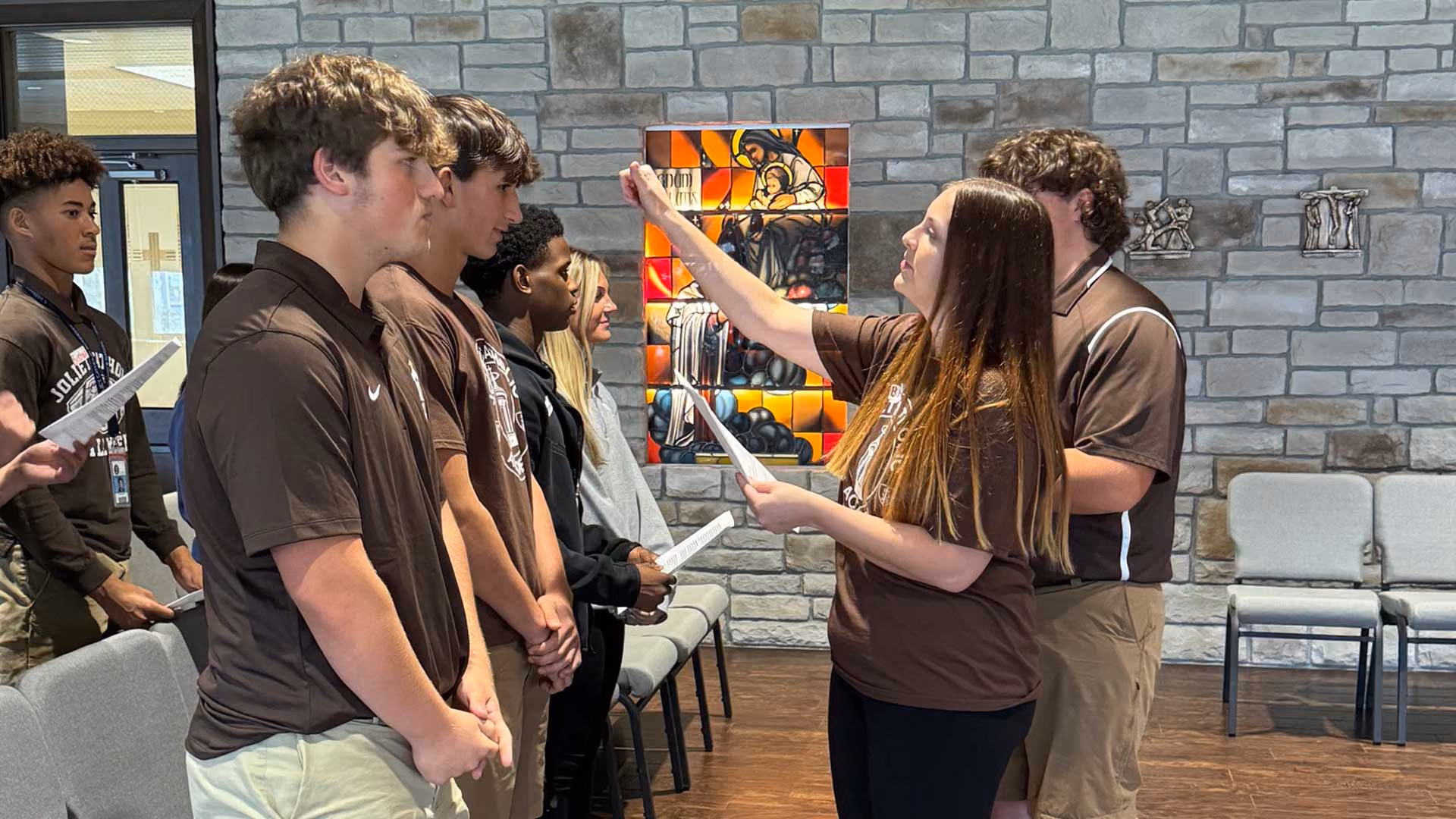 Catholic high school students praying together