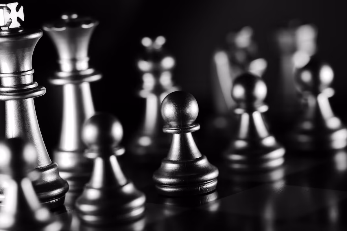 Detailed monochrome image of chess pieces, showcasing strategy and focus.