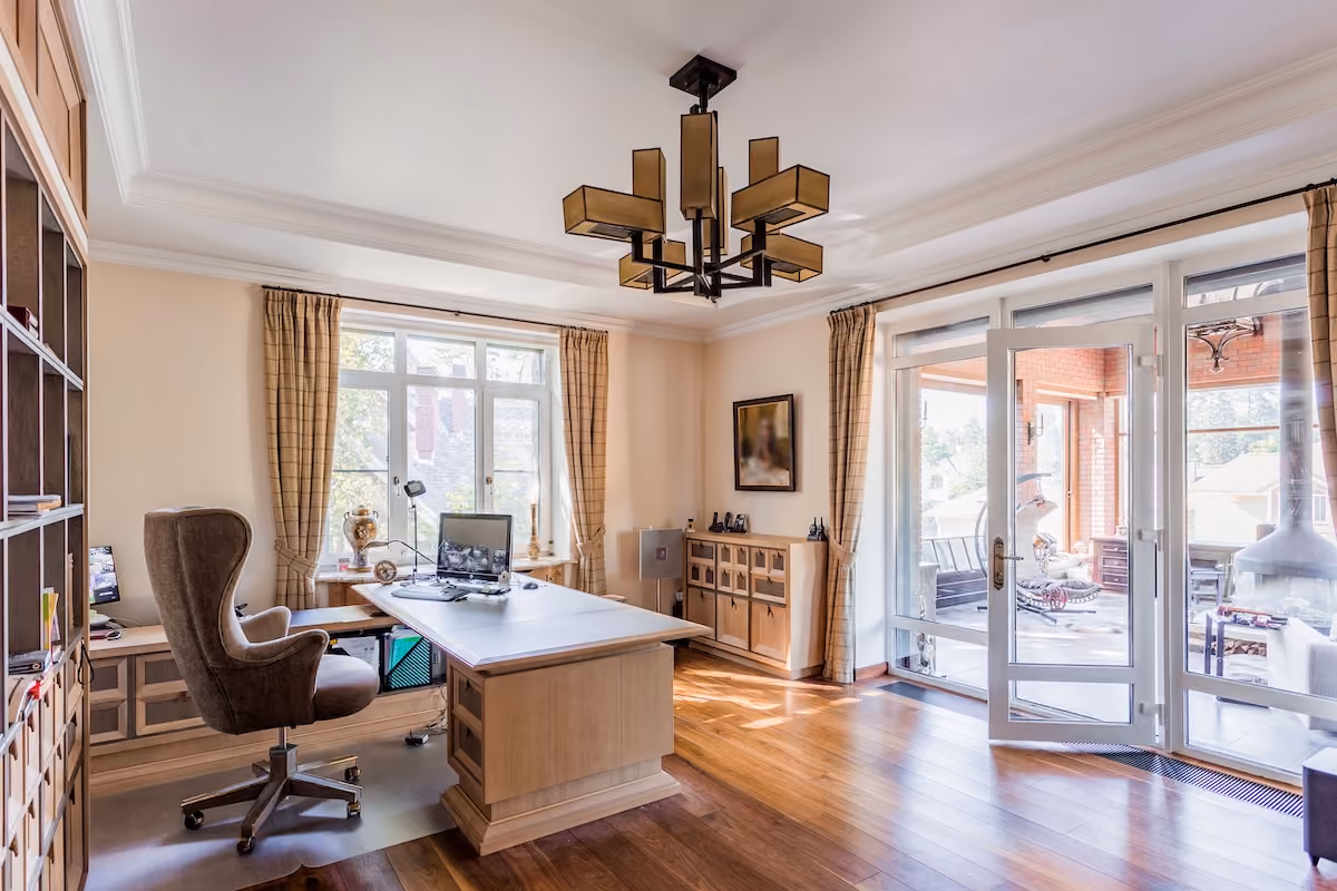 Spacious home office with modern decor and ample natural lighting, ideal for productivity.