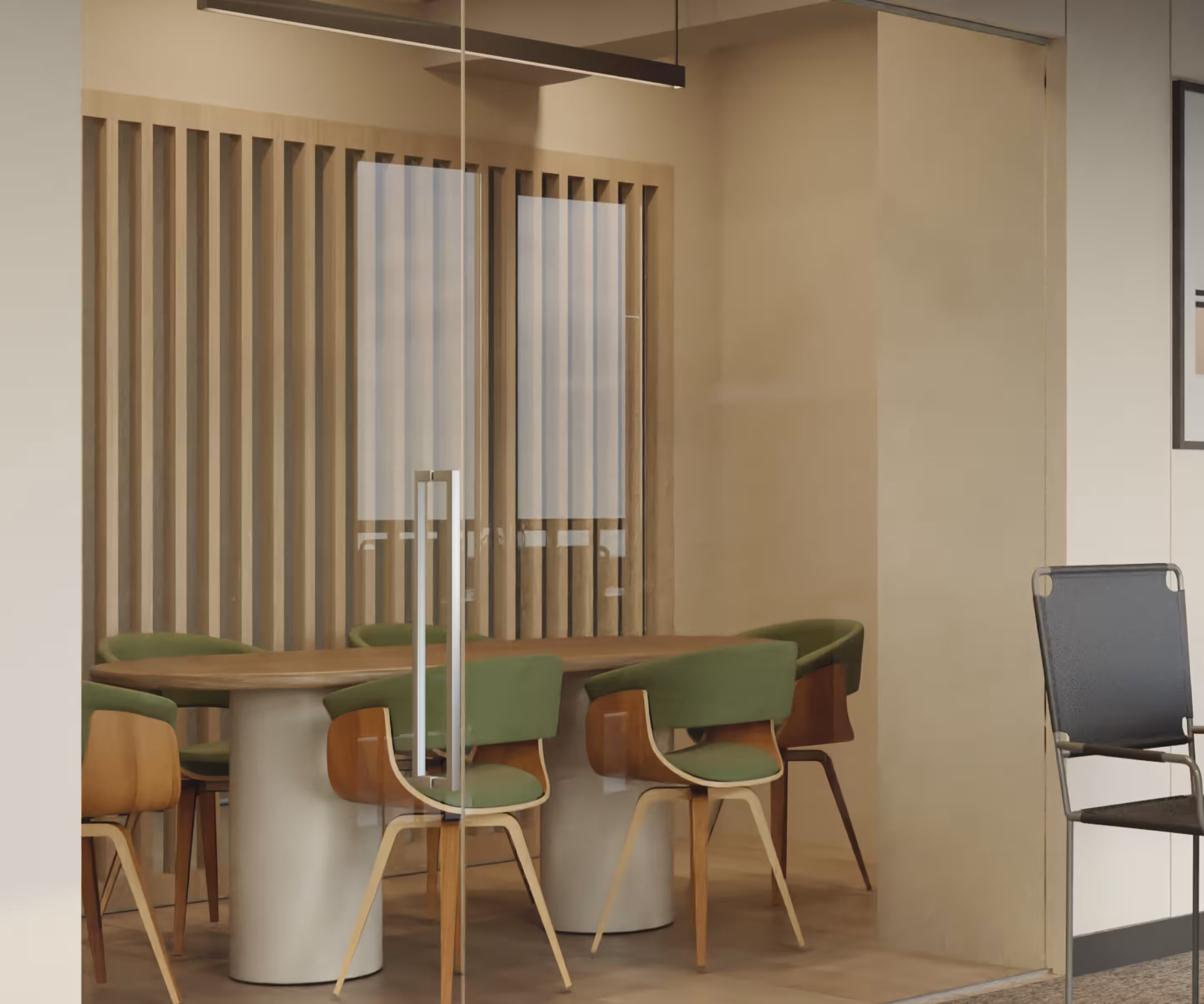A conference room with a wood-slat partition, a glass divider, and green upholstered chairs around a wood table.