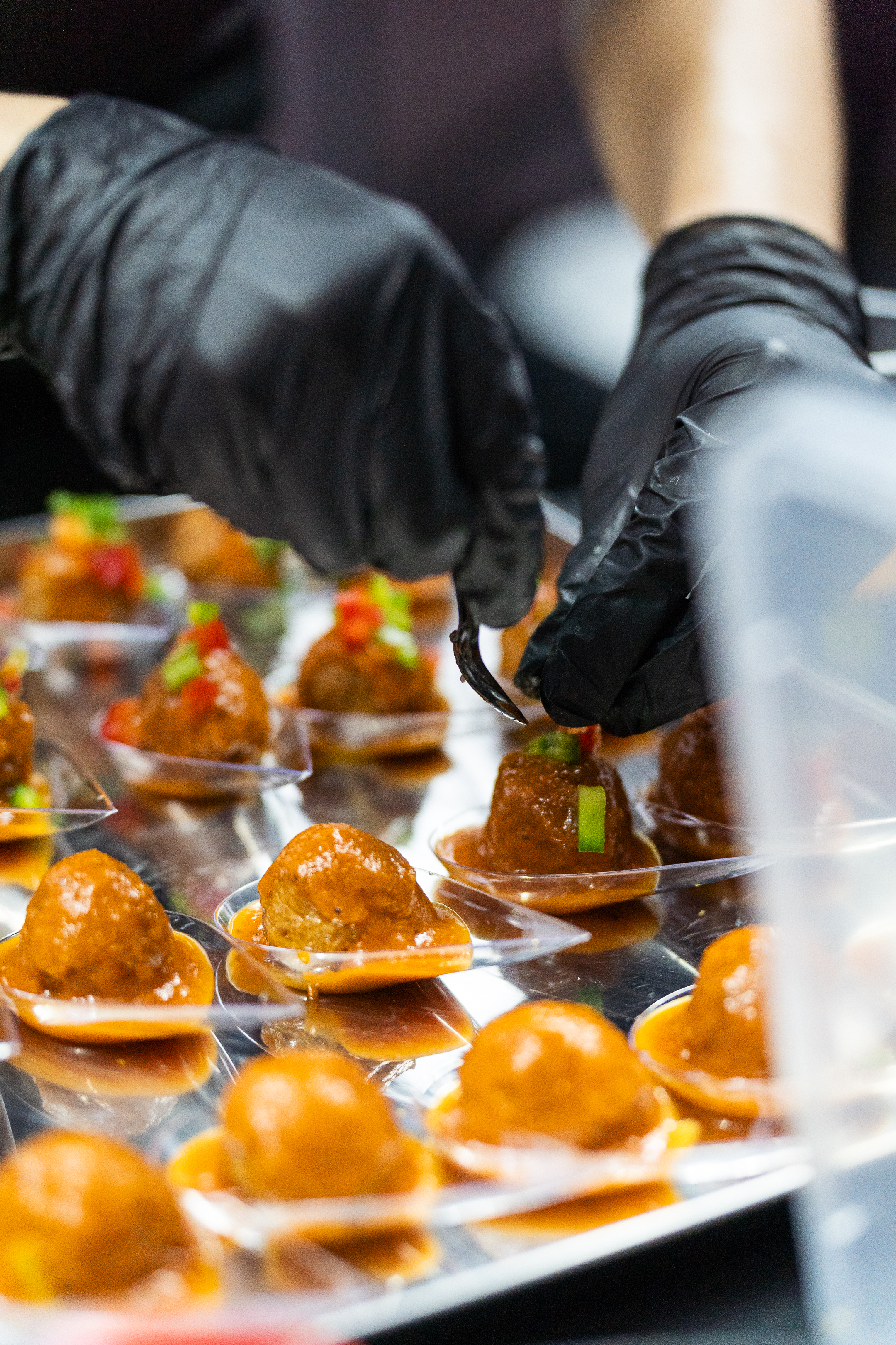 Chef plating canapés to order during service