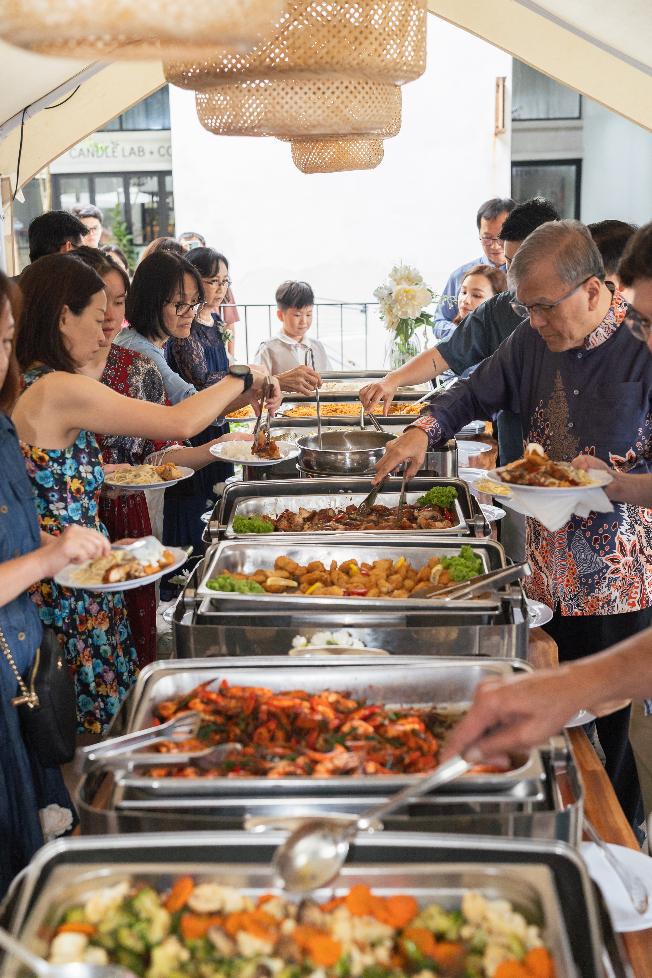 Guests serving themselves along a buffet line at a wedding