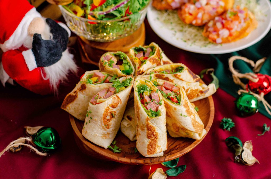 Ham and vegetable tortilla wraps on a wooden plate, iDoCatering Christmas 2021 catering menu