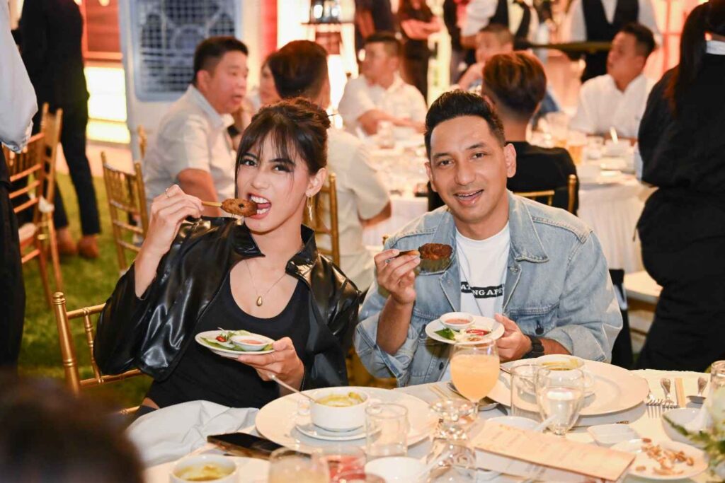 Guests enjoying grilled skewers at their banquet table during the AEON biker event 2025