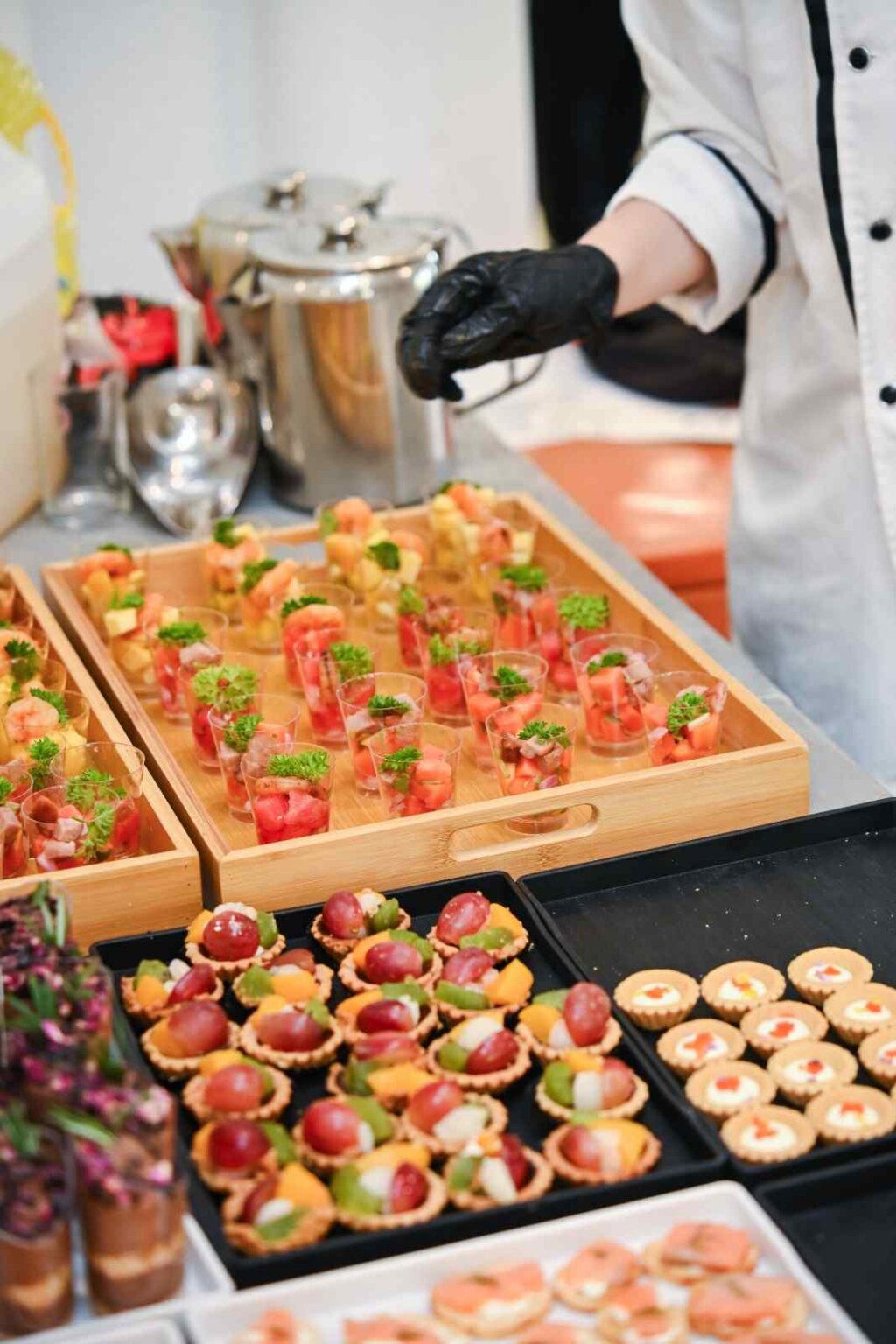 iDoCatering staff preparing appetiser cups and fruit tartlets at the AEON biker event 2025