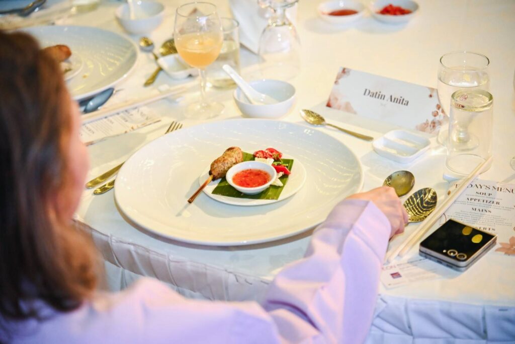 Plated chicken satay starter with chilli dip at a guest place setting, AEON biker event 2025