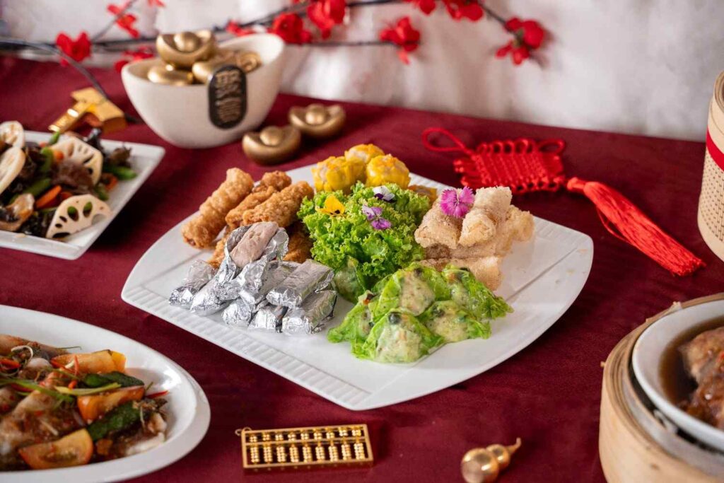 Dim sum platter with siu mai, green dumplings, foil-wrapped parcels and fried rolls, Chinese New Year 2026 menu