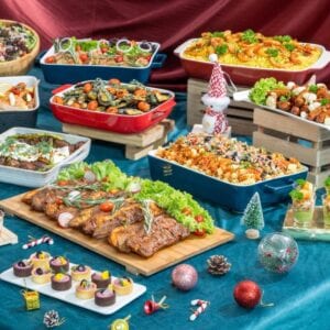 iDoCatering Christmas 2025 buffet spread with roast meat platter, baked pasta trays and mini desserts