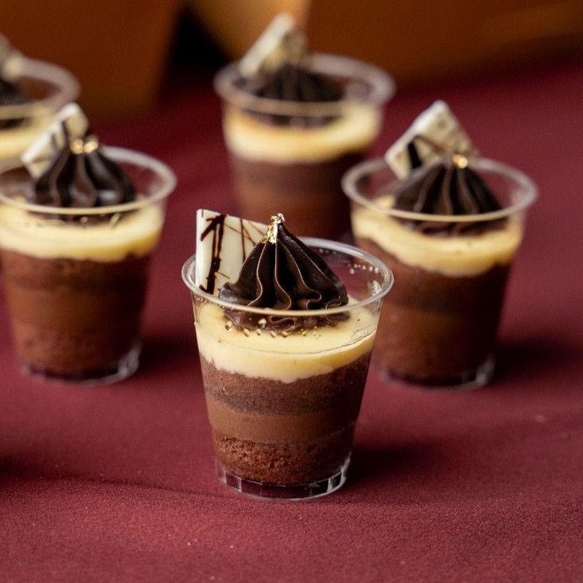 Chocolate mousse shot cups with piped ganache and white chocolate shards, iDoCatering Christmas 2025 dessert