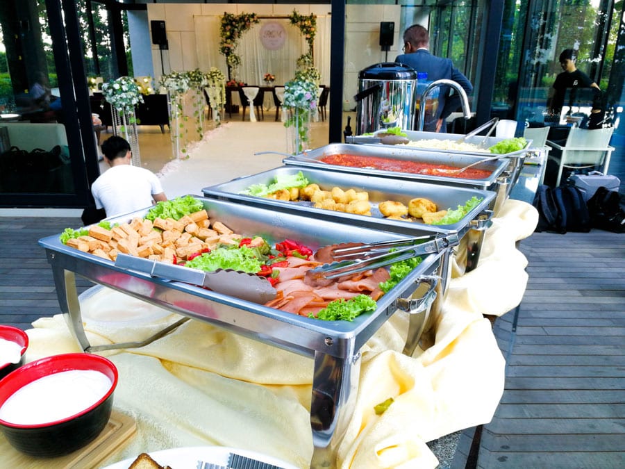 Chafing dishes of sliced meats, fried nuggets and pasta sauce, Classic Buffet Asian & Western package by iDoCatering