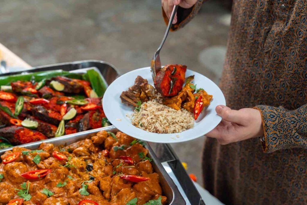 Tandoori-style fish and chicken masala served with rice at an office Deepavali buffet, 2025