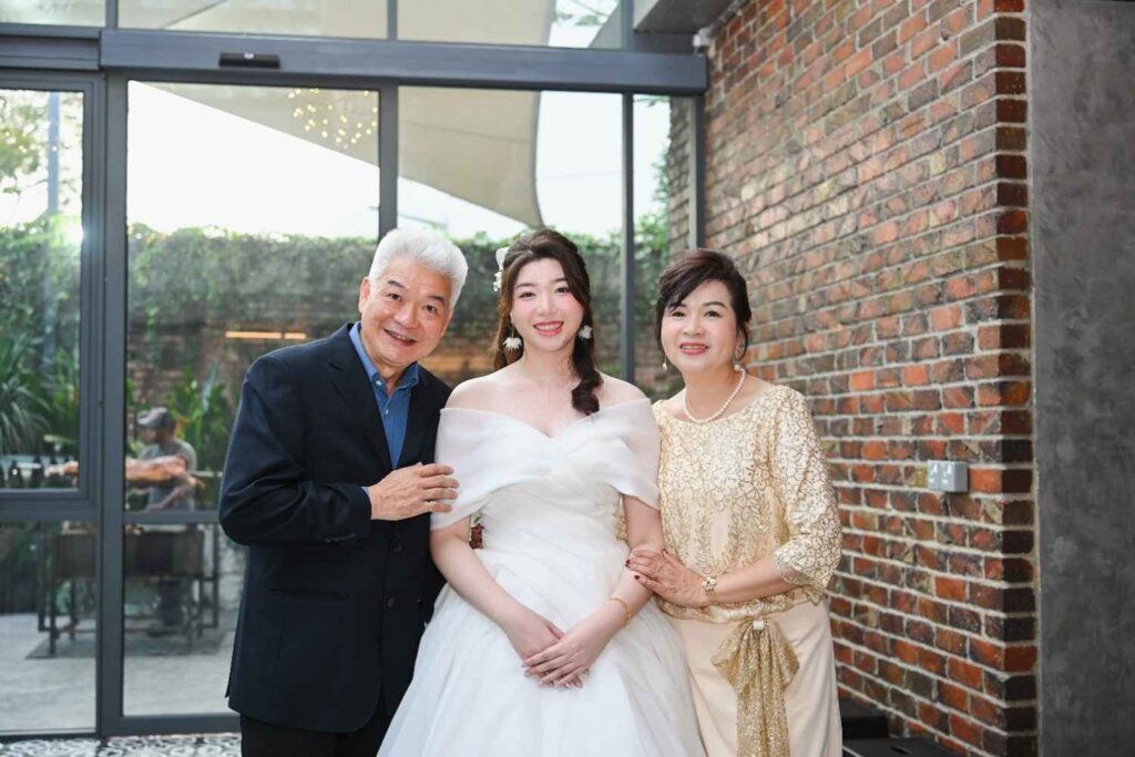 Bride posing with family members at ROM 8 Studio by Metal Bees during a wedding catered by iDoCatering