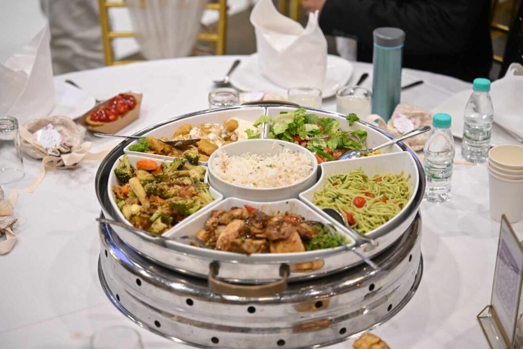 Segmented sharing platter with rice, pesto noodles and chicken at a ROM 8 Studio wedding, by iDoCatering