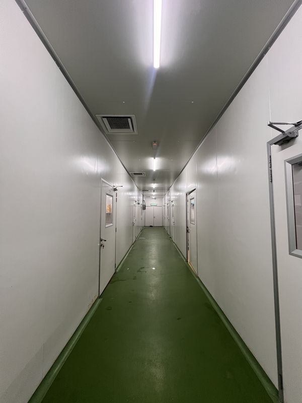 Main corridor of iDoCatering's kitchen, a green epoxy walkway with the separate preparation rooms opening off it