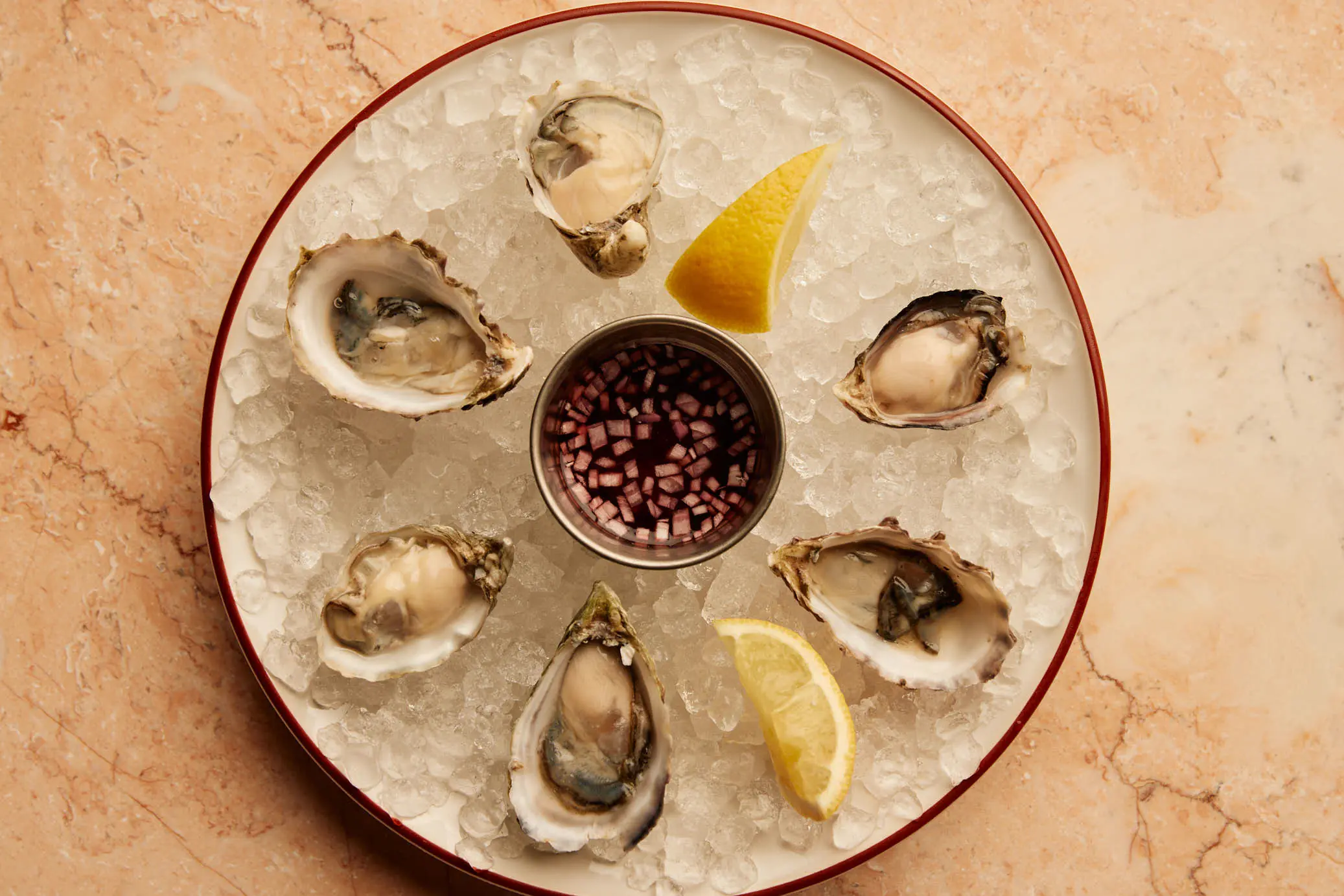 A plateau of oysters on ice with lemon and mignonette