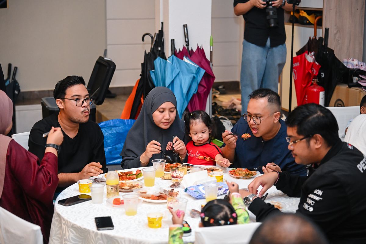 iDoCatering guests enjoying mini buffet at a small birthday party in KL — families eating together at a themed event