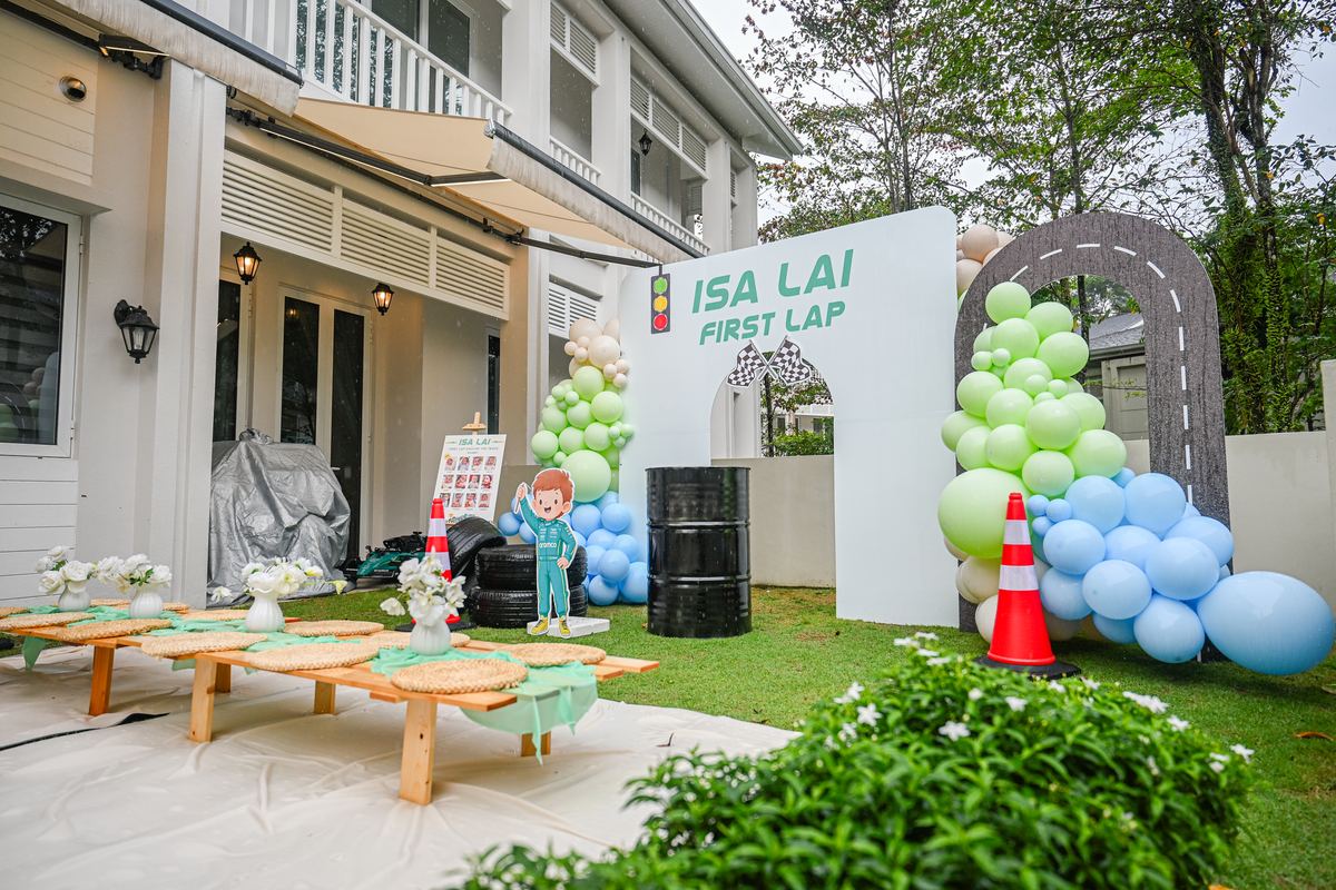 iDoCatering kids birthday party setup KL — outdoor racing theme with low tables and balloon arch