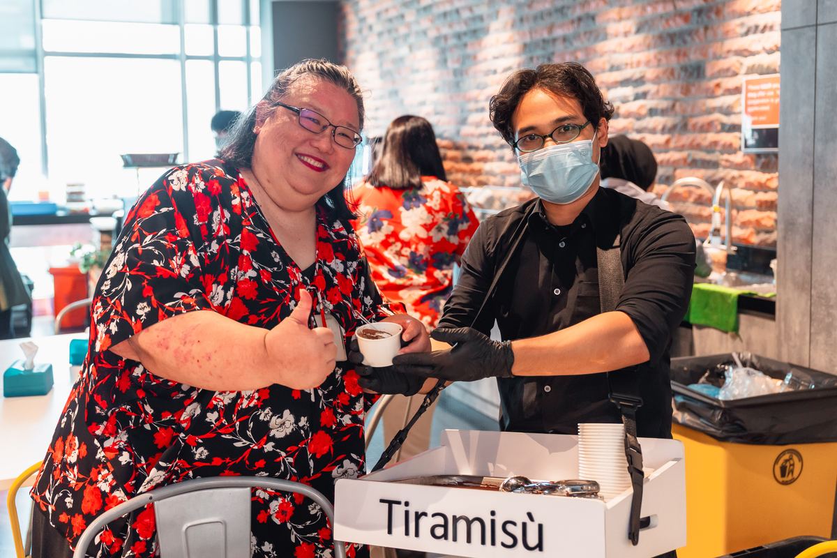 Lily from PwC Malaysia giving thumbs up while receiving tiramisu at her retirement farewell catered by iDo Catering KL