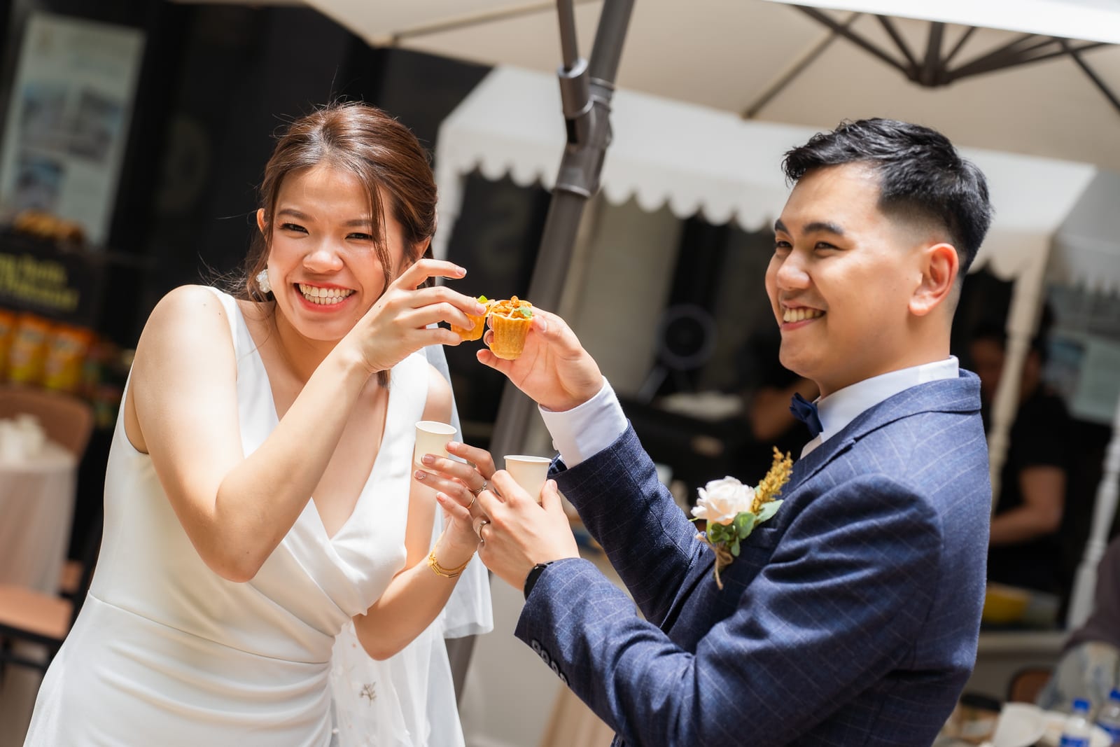 Bride and groom smiling during their wedding catering event at Cyberjaya