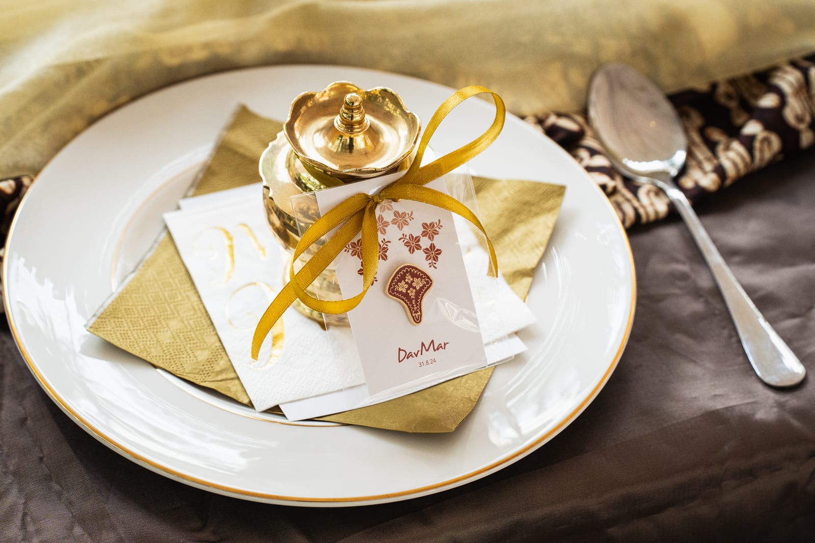 Gold place setting with personalised favour tag and bunga telur vessel at a Malay wedding — iDoCatering