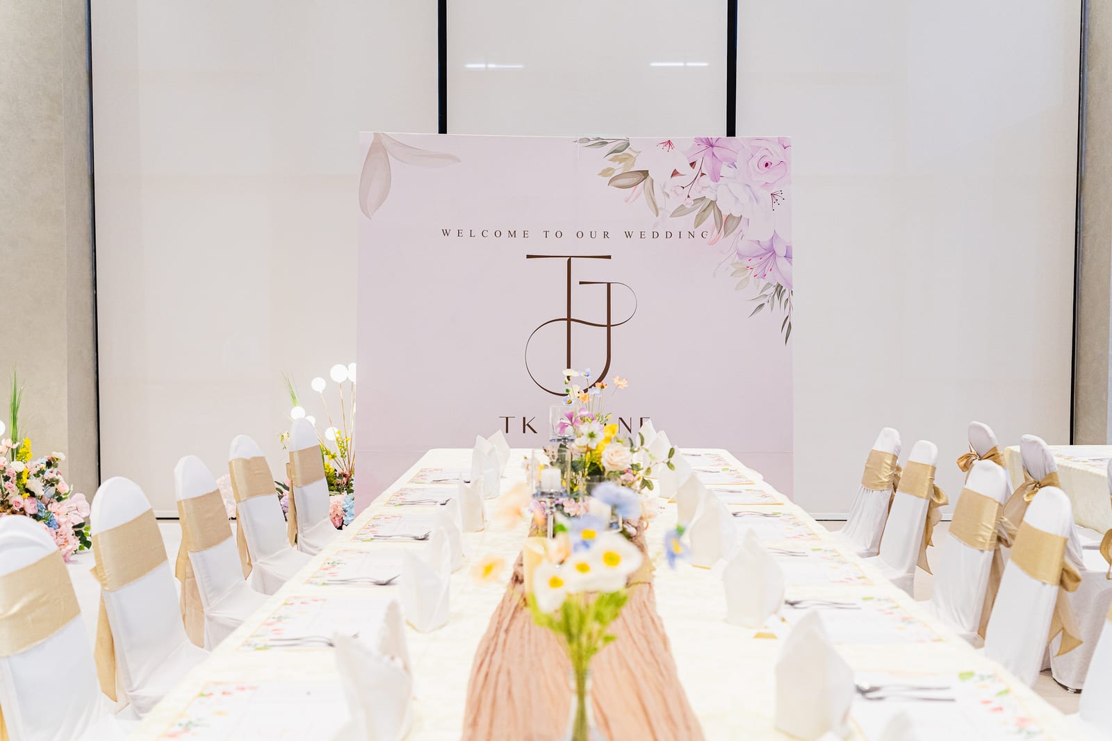 Elegant white floral wedding table and backdrop setup by iDoCatering
