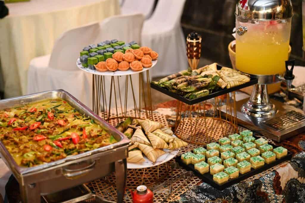 Hari Raya buffet by iDoCatering with vegetable curry, ketupat, grilled otak-otak, nyonya kuih and orange juice