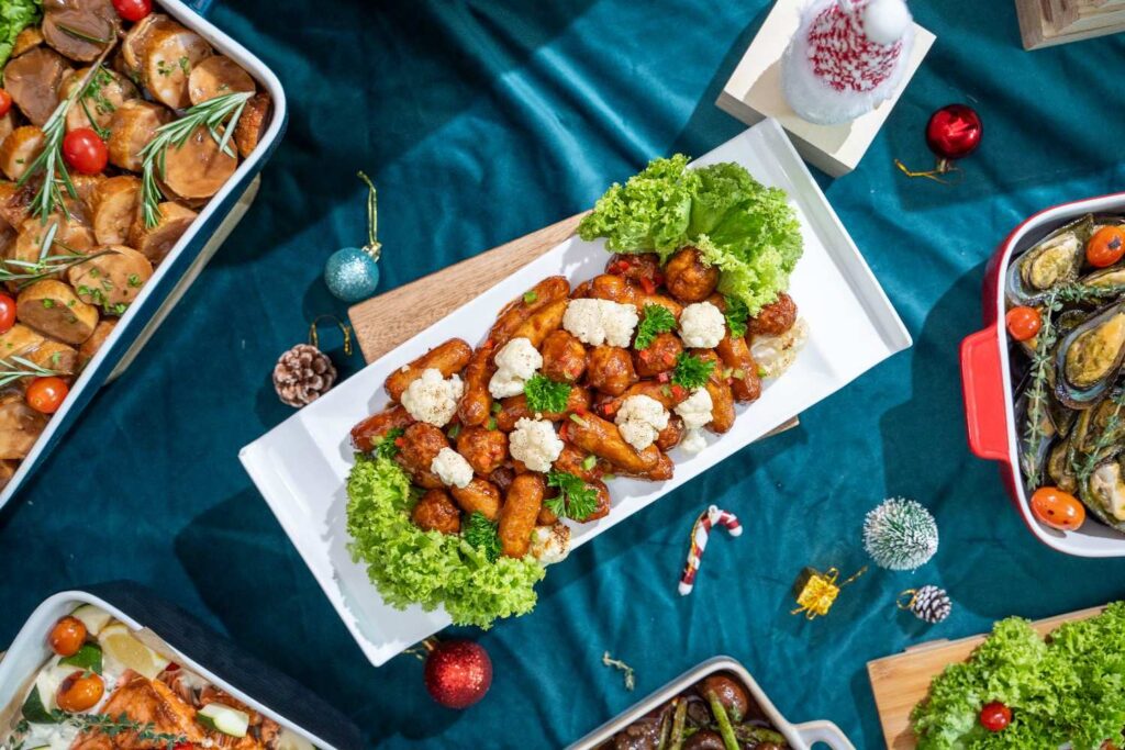 Top-down Christmas buffet by iDoCatering — glazed sausages with cauliflower, braised chicken, mussels and roast fish