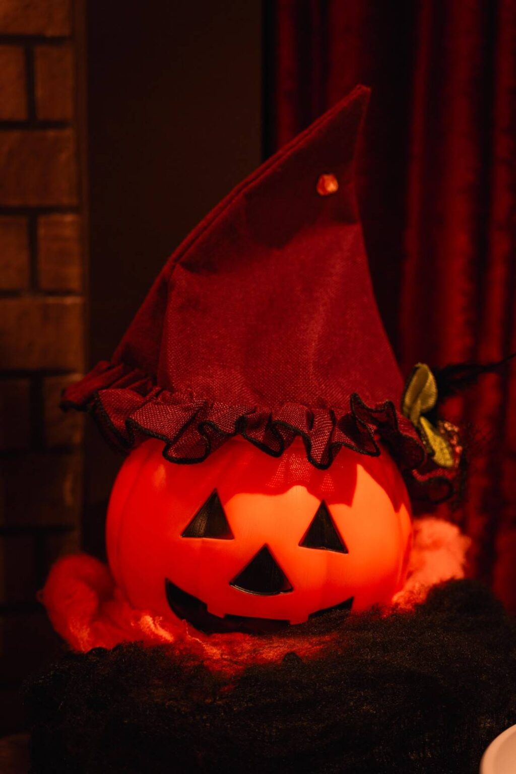 Jack-o'-lantern with witch hat decorating the Halloween party catering setup at Empire City