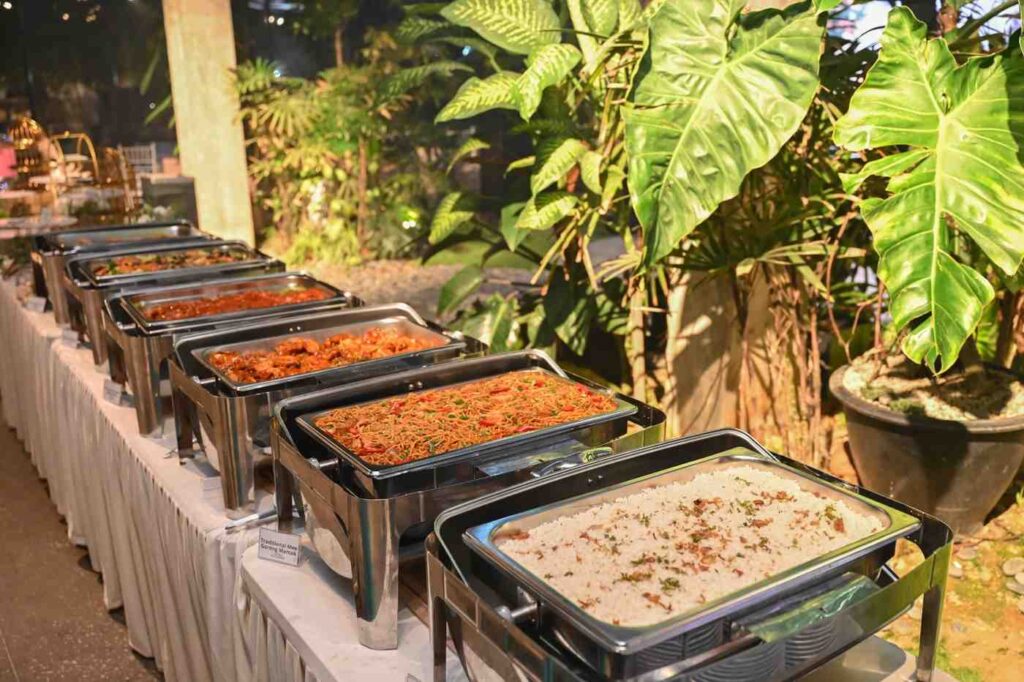 Garden buffet line of chafing dishes with herbed rice, mee goreng and curries - iDoCatering halal buffet catering