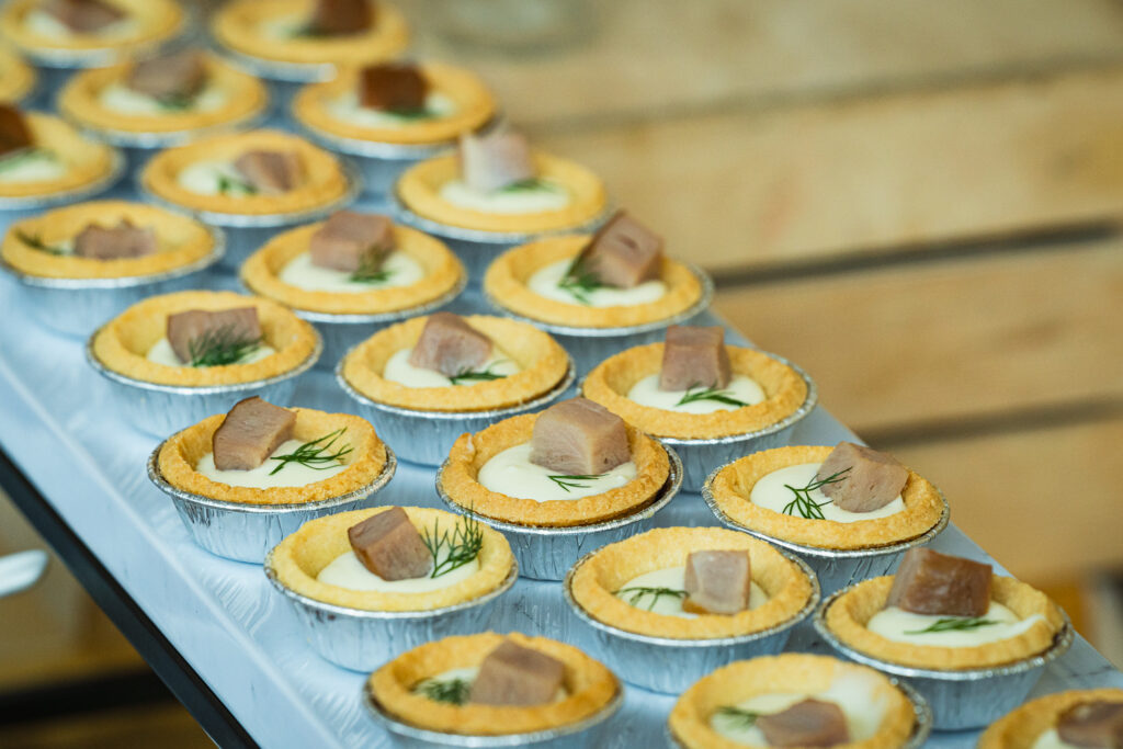 Cream cheese tartlets topped with tuna and dill on a serving tray - iDoCatering finger food catering