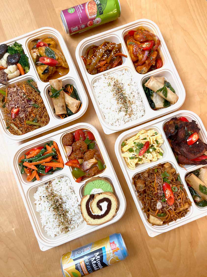 Four open iDoCatering bento boxes with meehoon, curry chicken, mee goreng and rice sets — corporate bento catering KL