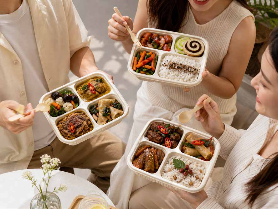 Colleagues sharing iDoCatering bento boxes at a team lunch — corporate bento catering KL & Selangor