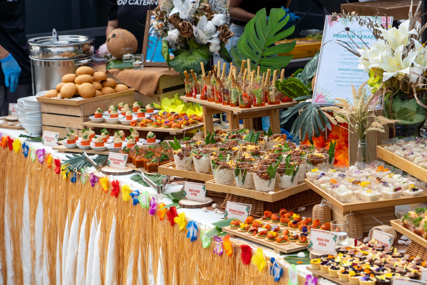 iDoCatering Premium Canapés Setup with nasi lemak cups, smoked salmon bites and tropical styling at a KL event