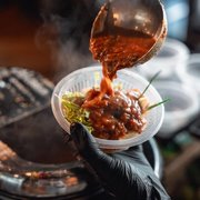 Nyonya asam laksa being served at a live station — iDoCatering