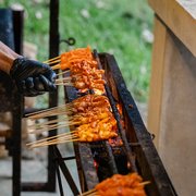 Chicken satay grilling at a live satay station — iDoCatering