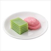 Assorted nyonya kuih — green kuih lapis and pink angku on a plate, iDoCatering light refreshment