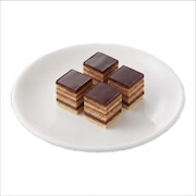 Platter of layered chocolate-glazed cake squares — iDoCatering buffet