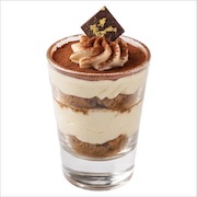 Layered tiramisu in a shot glass with cocoa dusting and a chocolate square — iDoCatering