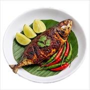 Whole grilled fish on banana leaf with lime and chillies — iDoCatering buffet