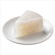 Wedge of clear coconut jelly set with coconut strands on a white plate — iDoCatering buffet